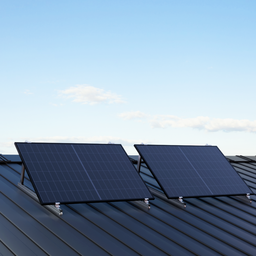 A digital rendering of a modern multi-story residential building with balconies equipped with solar panels.